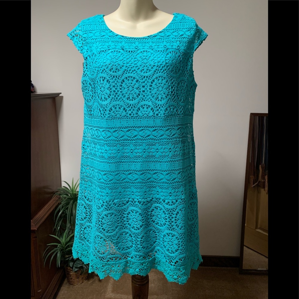 Crocheted sheath turquoise dress with polyester lining.
